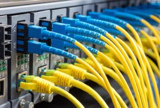 Fiber Optic cables connected to optic ports and UTP, Network cab Fiber Optic cables connected to optic ports and UTP, Network cables connected to ethernet ports.